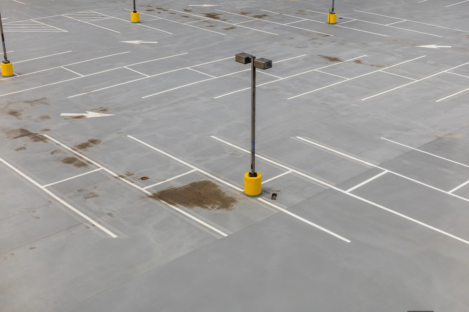 Place de stationnement vide délimitée par un marquage blanc sur l'asphalte